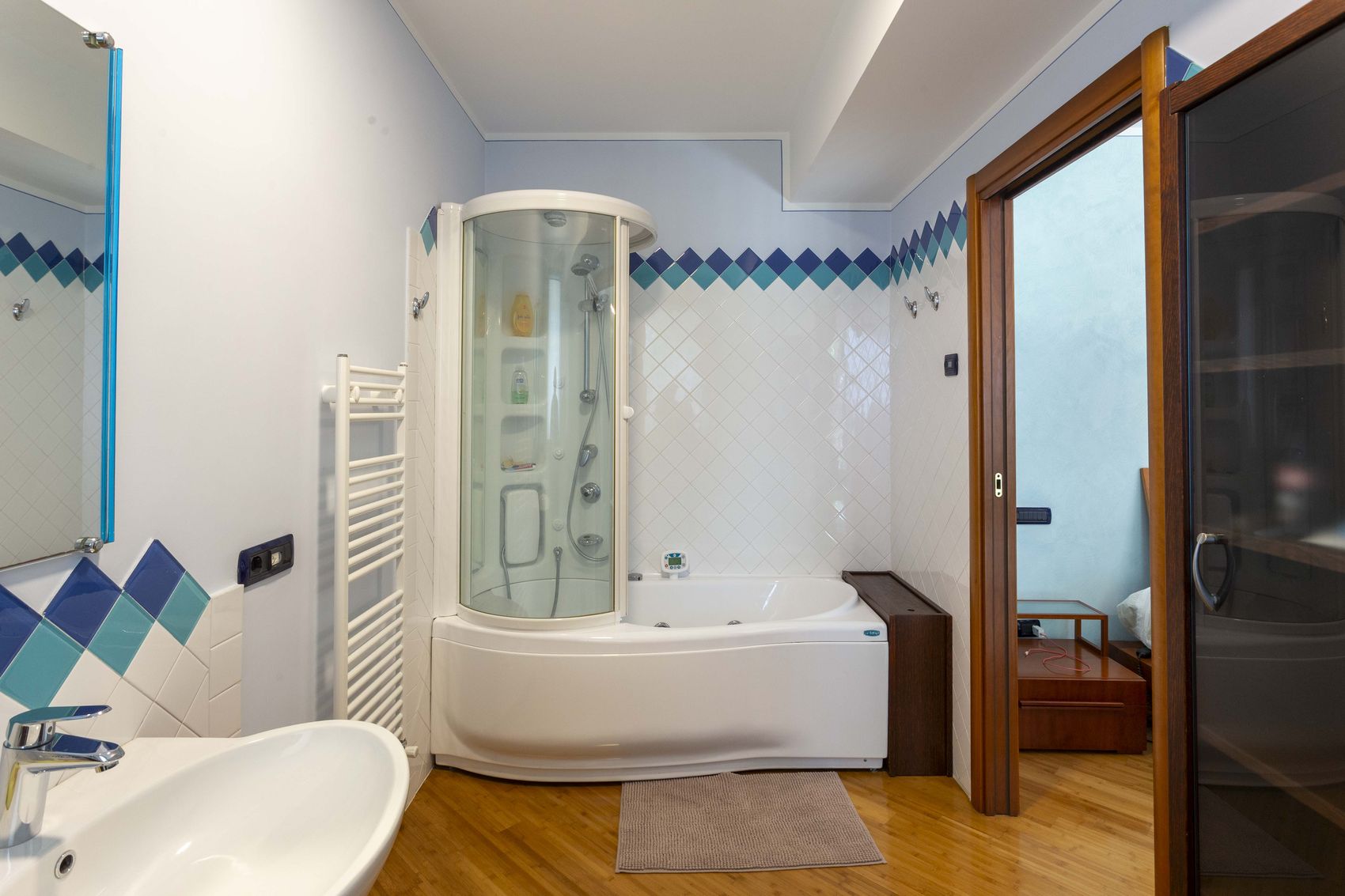 The master bathroom with a whirlpool bath and a steam shower cabin