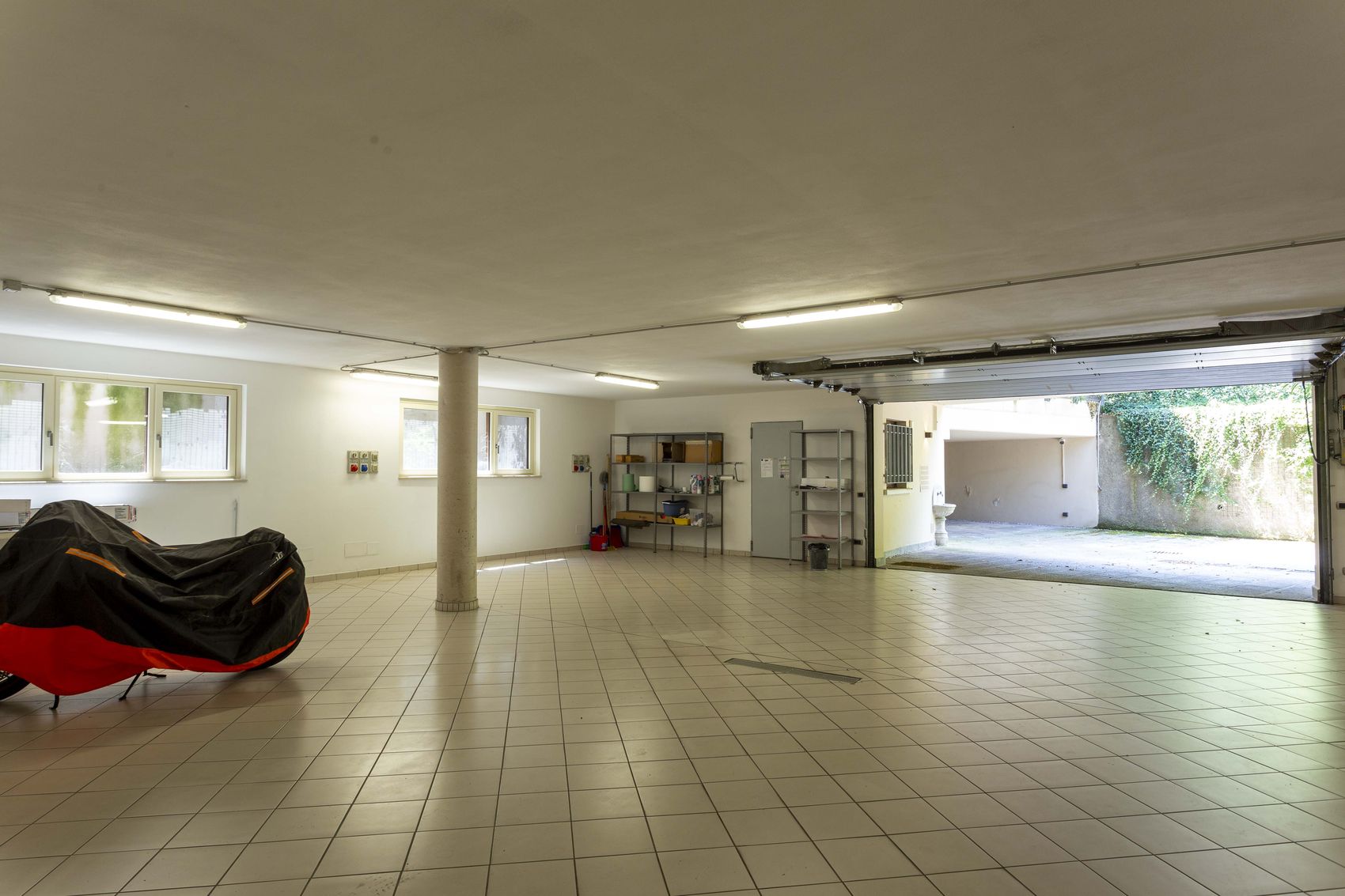 The garage with its door open to the drive