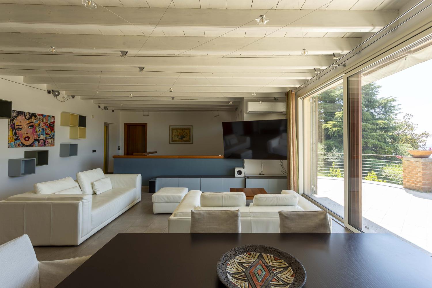 The main living room with sliding doors open onto the terrace